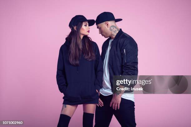 fashion portrait of rebel young couple - female rapper stock pictures, royalty-free photos & images