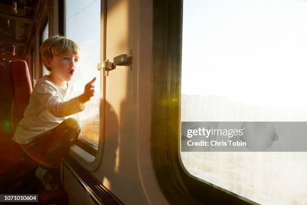 little boy in train pointing at something - nutzfahrzeug stock-fotos und bilder