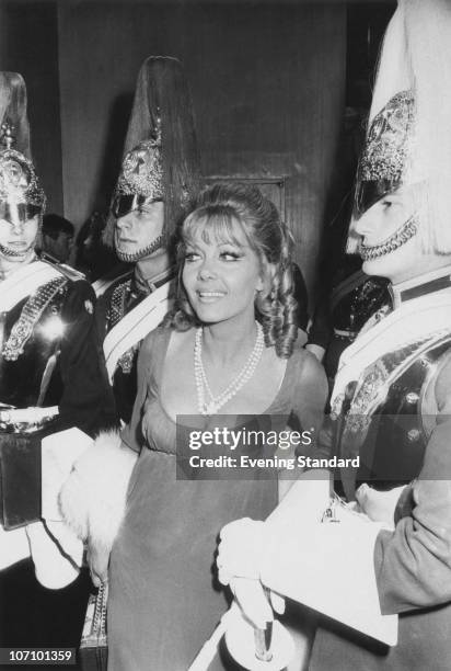 Polish-born actress Ingrid Pitt surrounded by Horse Guards of the Household Cavalry at the London premiere of the film 'Cromwell', 16th July 1970....