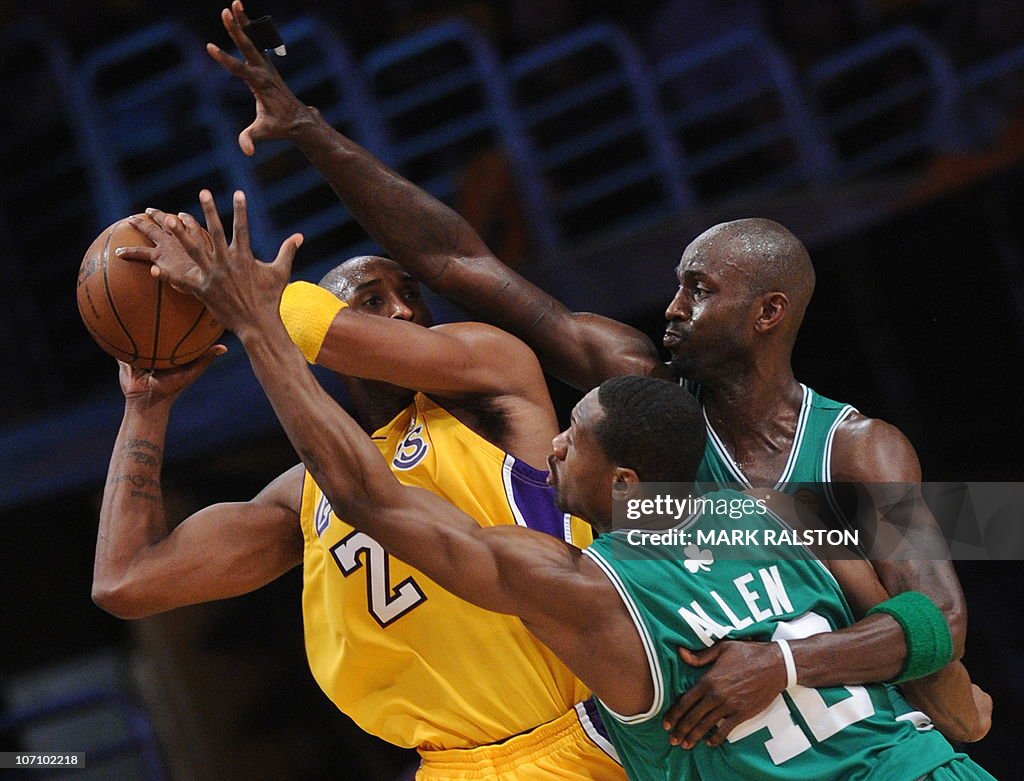 LA Lakers guard Kobe Bryant is guarded b