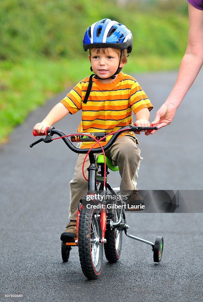 Bike Riding Learning Child Learning To Ride A Bike High-Res Stock Photo - Getty Images