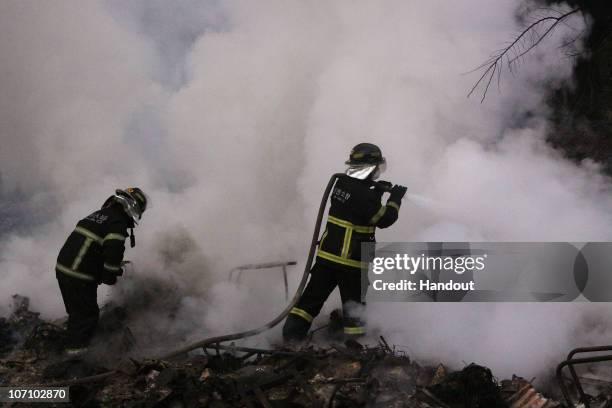 In this handout image provided by Incheon Fire and Safety Management Department, firefighters are seen extinguishing a fire after the damage caused...