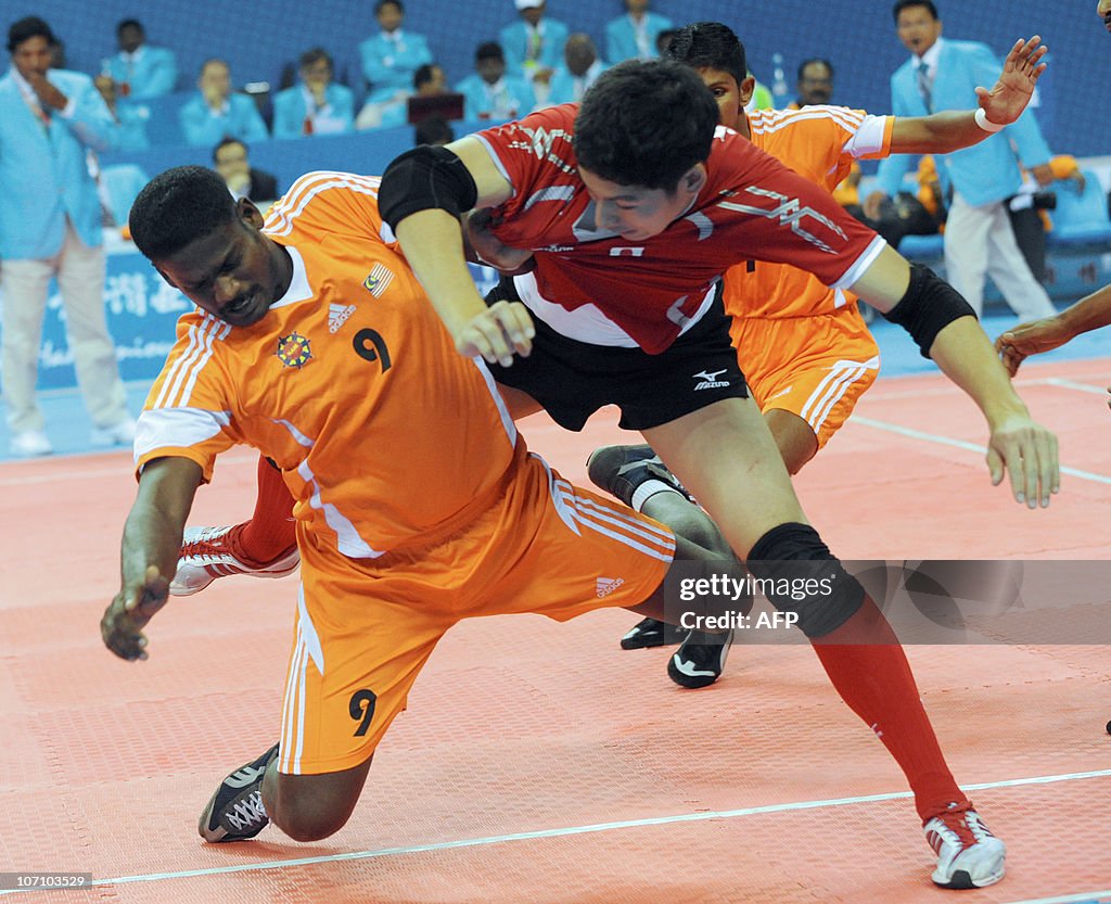 Jeevan Raman (L) of Malaysia tries to br