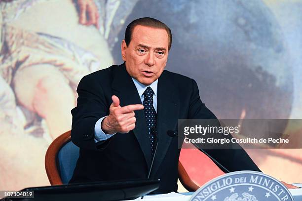 Italian Prime Minister Silvio Berlusconi gestures while he is attending a press conference to present new government measures for the youngsters,...