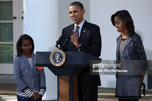 President Barack Obama speaks during a ceremony, where he pardoned the National Thanksgiving Turkey, named Apple, with daughters Sasha and Malia in...