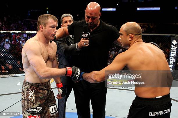 Matt Hughes and BJ Penn greet in the center of the octagon as referee Dan Miragliotta reviews the fight rules during their Welterweight bout part of...