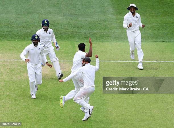 India celebrate the last wicket of Josh Hazlewood of Australia to win the test during day five of the First Test match in the series between...