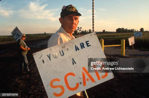 Striking miners form a picket line against scab labor outside a coal processing plant in August of 1993 in Booneville, Indiana.