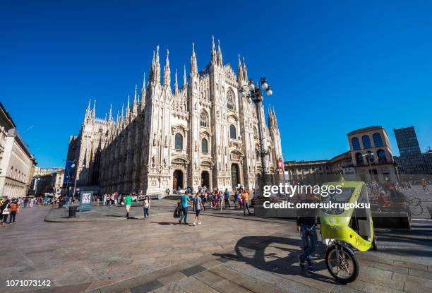 turista táxi moto no duomo praça (mariae nascenti) milão, itália - catedral de milão - fotografias e filmes do acervo