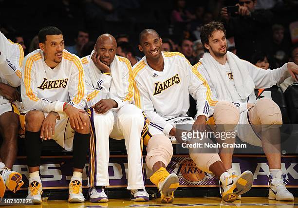 Matt Barnes, Lamar Odom, Kobe Bryant and Pau Gasol of the Los Angeles Lakers smile from the bench during the game against the Golden State Warriors...