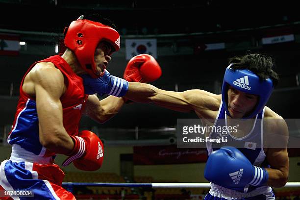 Katsuaki Susa of Japan competes against Rey Saludar of Philippines in the Men's 52kg Semifinal at Foshan Gynasium during day twelve of the 16th Asian...