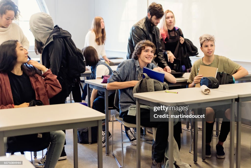 Multi-ethnic group of College students leaving classroom.
