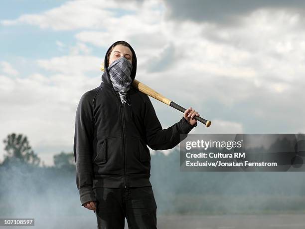 protester with baseball bat - mask confrontation stock pictures, royalty-free photos & images