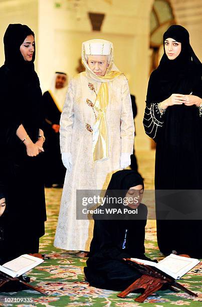 Queen Elizabeth II watches as girls read the Qur�an at the Sheikh Zayed Mosque on November 24, 2010 in Abu Dhabi, United Arab Emirates. Queen...