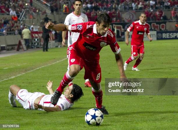 Benfica's forward Eduardo Salvio challenges Hapoel Tel Aviv's defender Dedi Ben Dayan during their UEFA Champions League group B football match at...