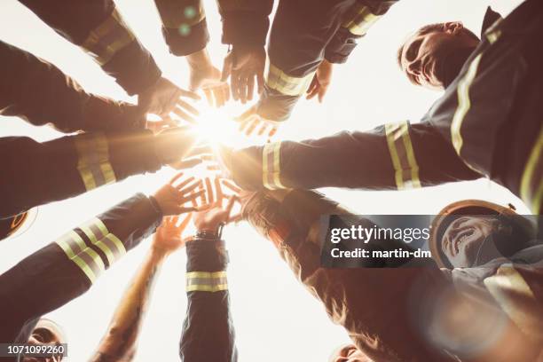 firefighters doing high five - rescue team stock pictures, royalty-free photos & images