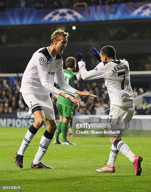 Peter Crouch of Tottenham Hotspur celebrates scoring Tottenham's third goal with Aaron Lennon during the UEFA Champions League Group A match between...
