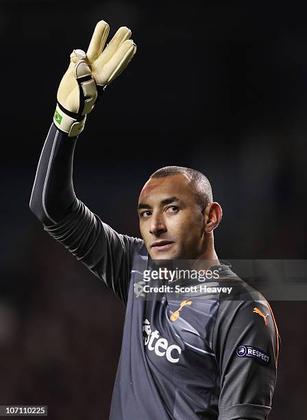 Heurelho Gomes of Tottenham Hotspur holds up three fingers to signify the three goals scored by his team during the UEFA Champions League Group A...