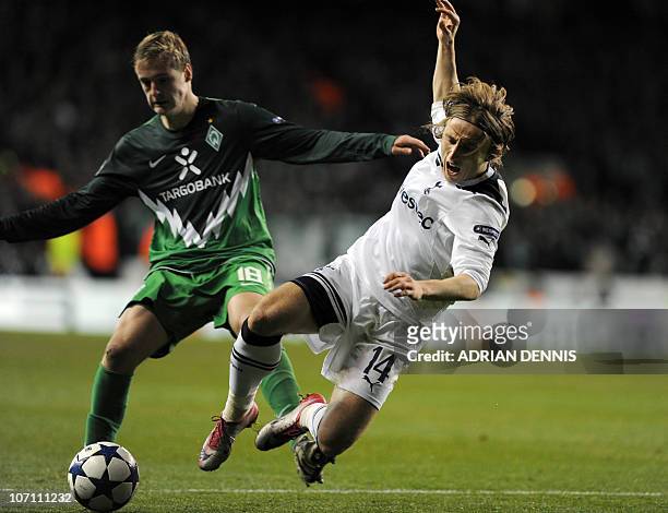 Tottenham Hotspurs' Croatian player Luka Modric is fouled by Werder Bremen's striker Felix Kroos during the UEFA Champions League group A football...