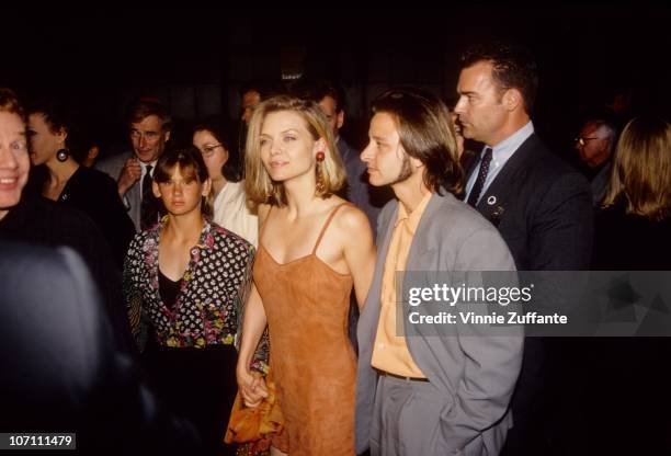 Actors Michelle Pfeiffer and Fisher Stevens attend the premiere of 'Batman Returns' on June 16, 1992 in Los Angeles, California.