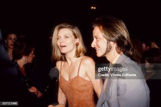 Actors Michelle Pfeiffer and Fisher Stevens attend the premiere of 'Batman Returns' on June 16, 1992 in Los Angeles, California.