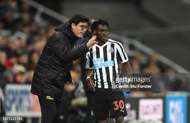 Newcastle coach Mikel Antia talks with winger Christian Atsu during the Premier League match between Newcastle United and Wolverhampton Wanderers at...