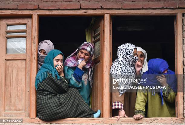 Kashmiri women cry during the funeral procession of slain teenaged militant Mudasir Ahmad Parrey in Hajin, north of Srinagar on December 10, 2018. -...