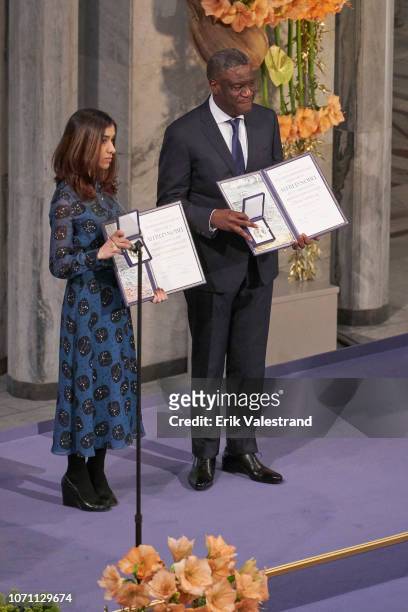 Dr. Denis Mukwege and Nadia Murad pose on stage after receiving the Nobel Peace Prize 2018 at Oslo City Town Hall on December 10, 2018 in Oslo,...