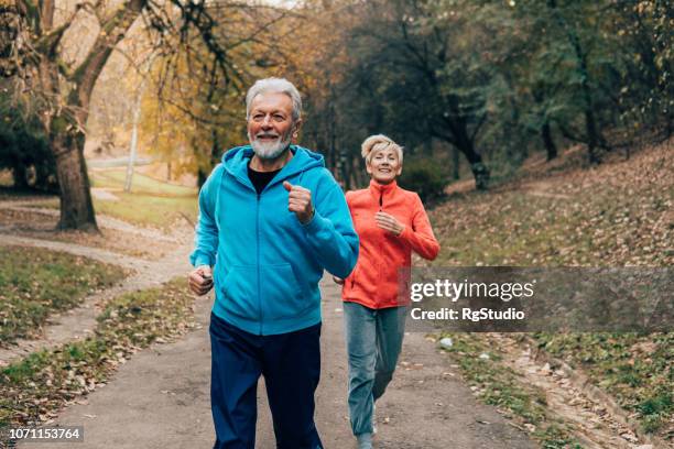 älteres paar joggen im freien - old woman running stock-fotos und bilder