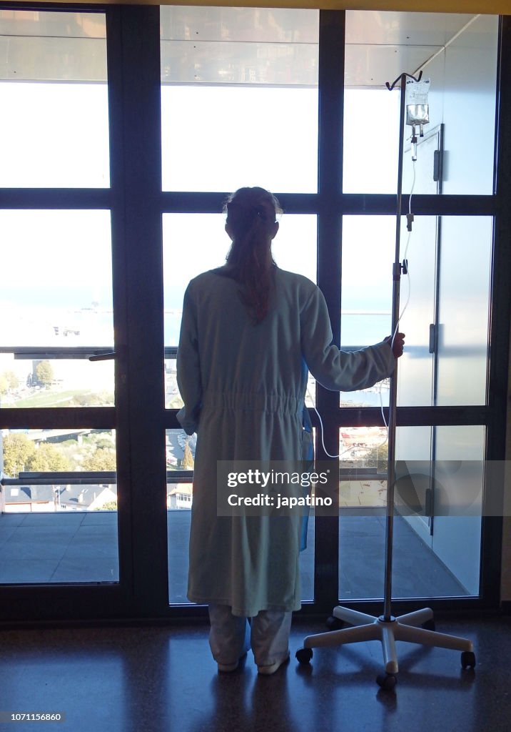 Sick woman with a iv drip in her neck to give her medicines