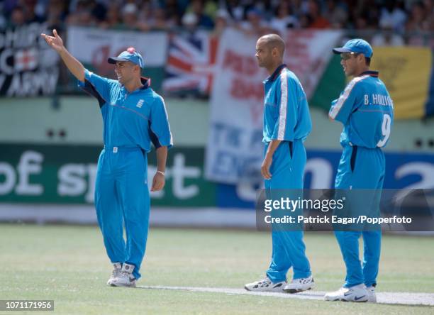 England captain Adam Hollioake gestures as he sets the field for bowler Dean Headley watched by Ben Hollioake during the Cable and Wireless Trophy...
