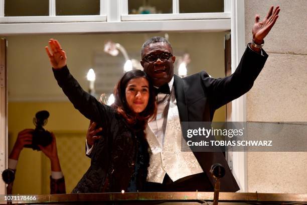 Nobel prize laureates Congolese gynecologist Denis Mukwege and Iraqi Yazidi-Kurdish human rights activist Nadia Murad greet the crowd from the...