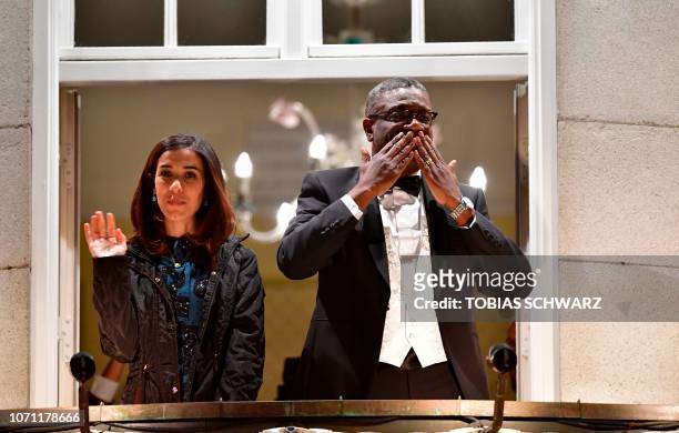 Nobel prize laureates Congolese gynecologist Denis Mukwege and Iraqi Yazidi-Kurdish human rights activist Nadia Murad greet the crowd from the...