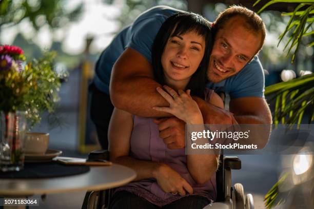 happy couple portrait, women on wheelchair - weakness stock pictures, royalty-free photos & images