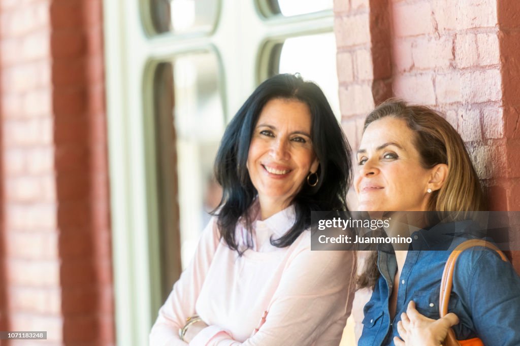 Smiling mature women posing looking at the camera