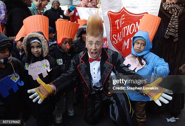 Bello Nock and children from The Salvation Army during Comic Daredevil Bello Nock Changes Clock Nine Stories in Air for Daylight Savings Time - March...