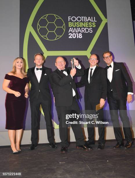 Of The Year award winner Andy Holt of Accrington Stanley poses with with presenters Hayley McQueen and Ed Chamberlin during the Football Business...