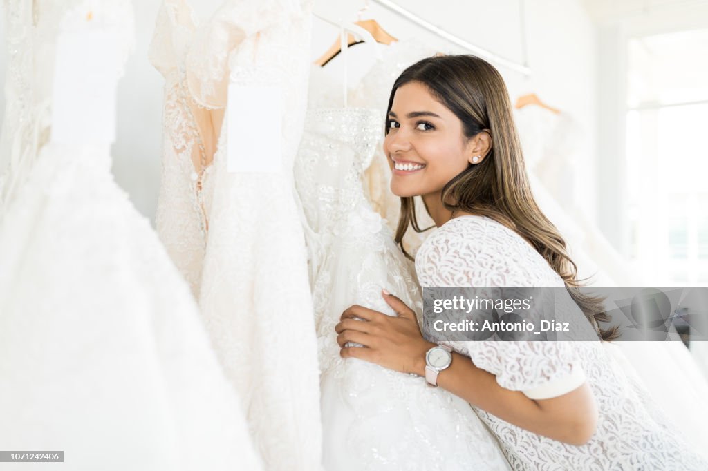 Woman Buying Beautiful Marriage Gown In Store