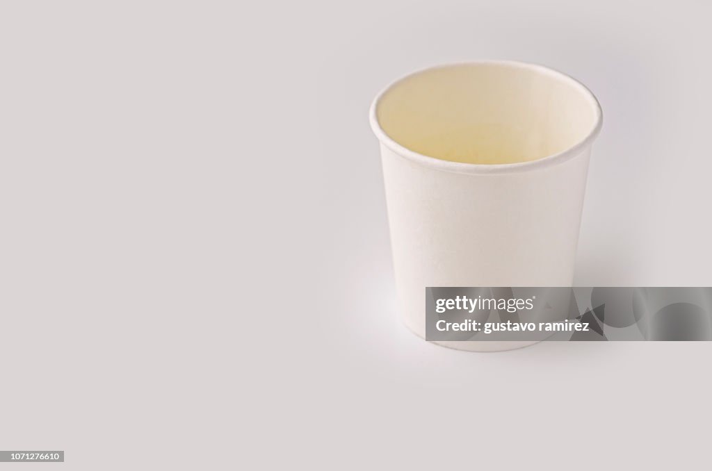 White plastic cup on white background