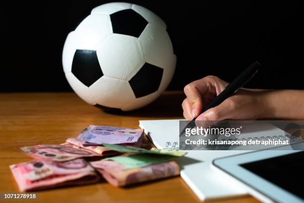 oconcept of getting money with bets in  football,football betting - sports betting stock-fotos und bilder