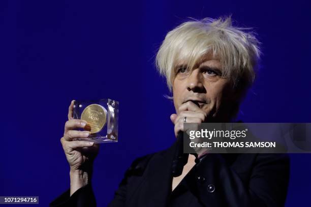 French singer Nicolas Sirkis from French rock band Indochine celebrates after receiving the "French variety music" award during the SACEM Grand Prix...