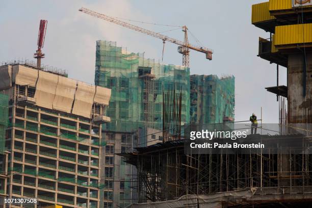 Construction workers on site as multiple buildings are constructed along the Galle Face on November 13, 2018 in Colombo, Sri Lanka. In just a few...
