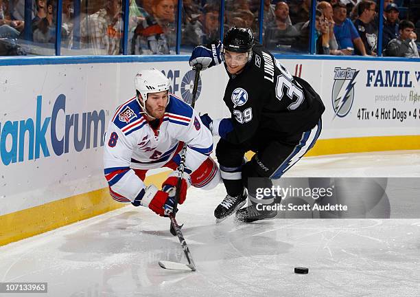 Brandon Prust of the New York Rangers dives to get to the puck before Mike Lundin of the Tampa Bay Lightning during the second period at the St. Pete...