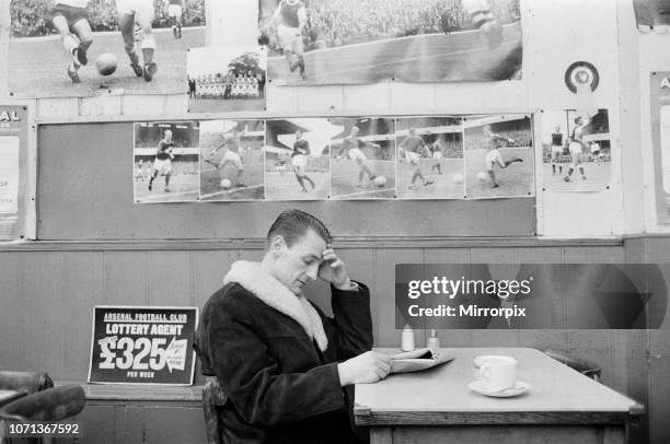 Arsenal inside forward George Eastham sits with a cup of tea in a cafe near his club's Highbury ground after hearing he had been dropped for the...