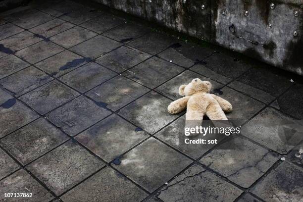 big teddy bear falling down on the roof - child mortality stock pictures, royalty-free photos & images