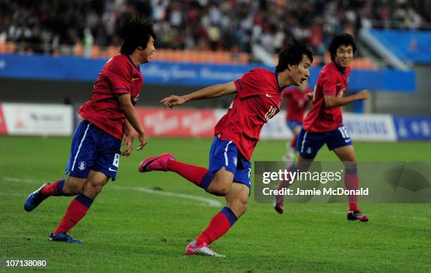 Dong Won Ji of South Korea celebrates scoring the winning goal in the Men's Bronze Medal between South Korea and Iran at Tianhe Stadium during day...