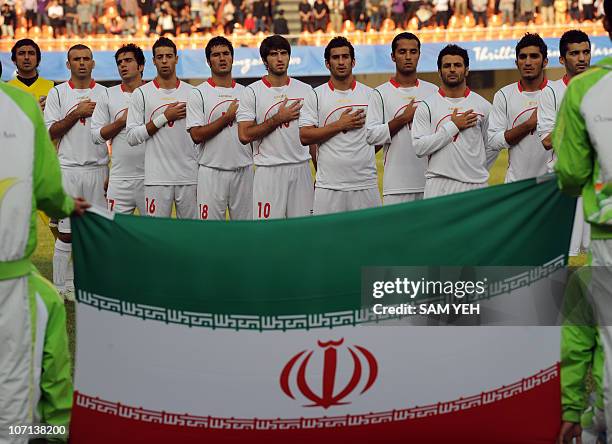 Iran's football team sing the national anthem before comepeting against South Korea at the men's football bronze match during the 16th Asian Games in...