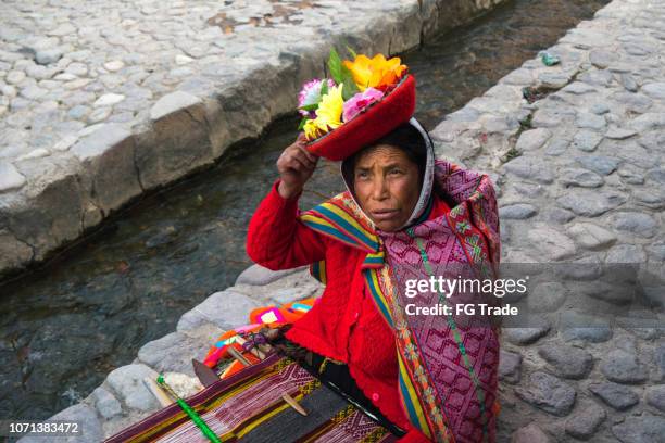 mujer peruana tejer la lana de alpaca color en perú en ollantaytambo - quechuas fotografías e imágenes de stock