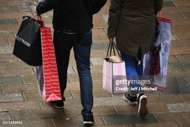 Black Friday shoppers in Buchan Street carry bags on November 23, 2018 in Glasgow, Scotland. Crowds of shoppers are out looking for bargains during...