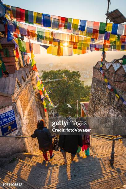 kathmandu prayer flags sunrise on swayambhunath monkey temple pilgrims nepal - katmandu stock pictures, royalty-free photos & images